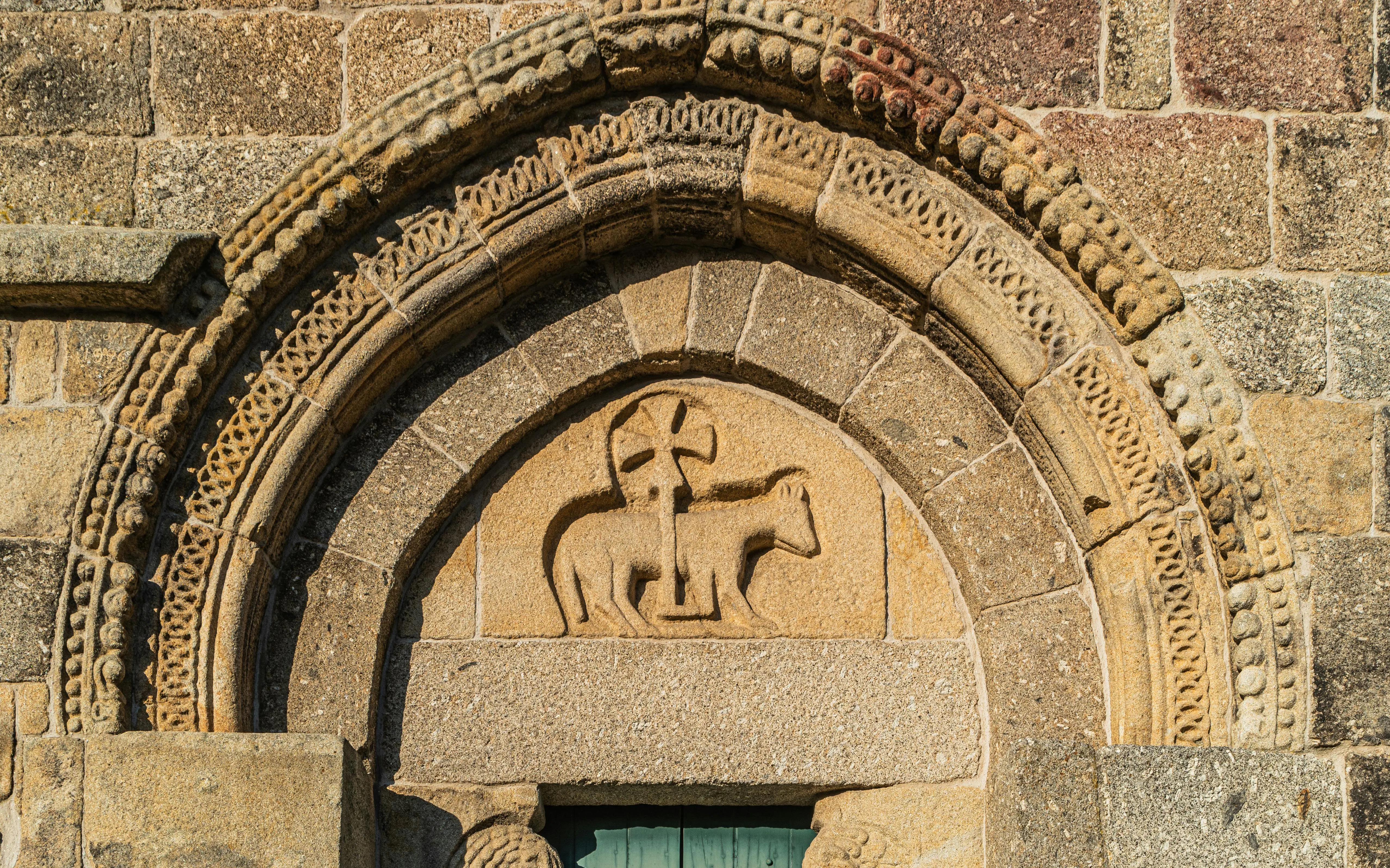 Stone arch with Romanesque carvings at Monastery of Bravaes, Ponte da Barca, Portugal.