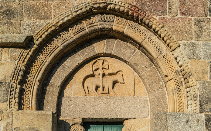 Stone arch with Romanesque carvings at Monastery of Bravaes, Ponte da Barca, Portugal.