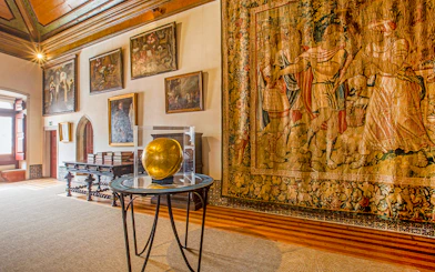 National Palace of Sintra Camarim with tapestries and paintings displayed.