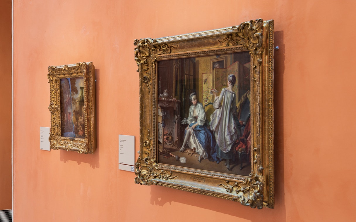 Paintings on display at the Thyssen Museum, featuring ornate frames and historical scenes.