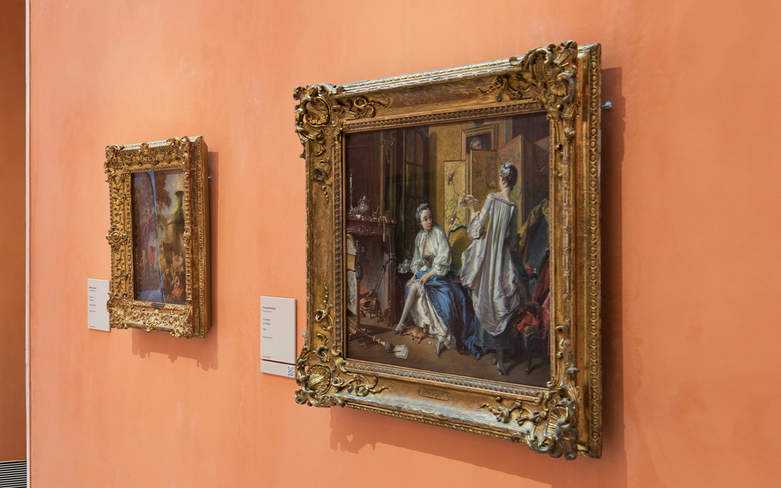 Paintings on display at the Thyssen Museum, featuring ornate frames and historical scenes.