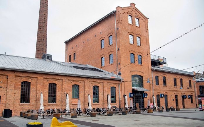 Historic brick building with outdoor seating in Warsaw, Poland.