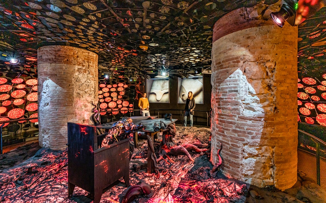 Casa Batlló interior with unique lighting and brick columns in Barcelona.