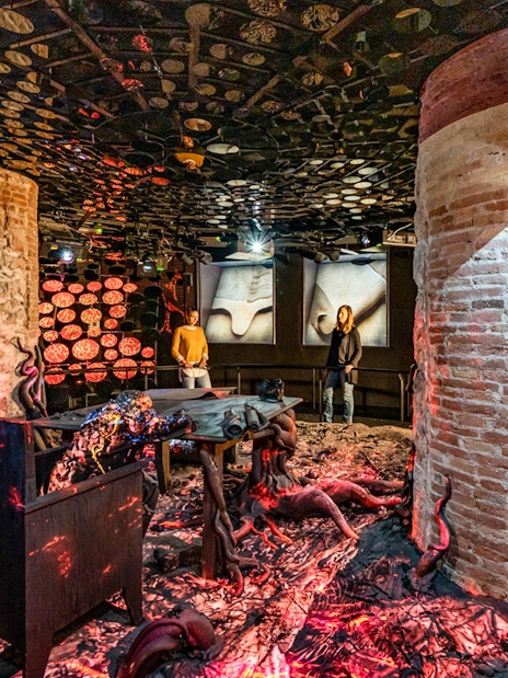 Casa Batlló interior with unique lighting and brick columns in Barcelona.