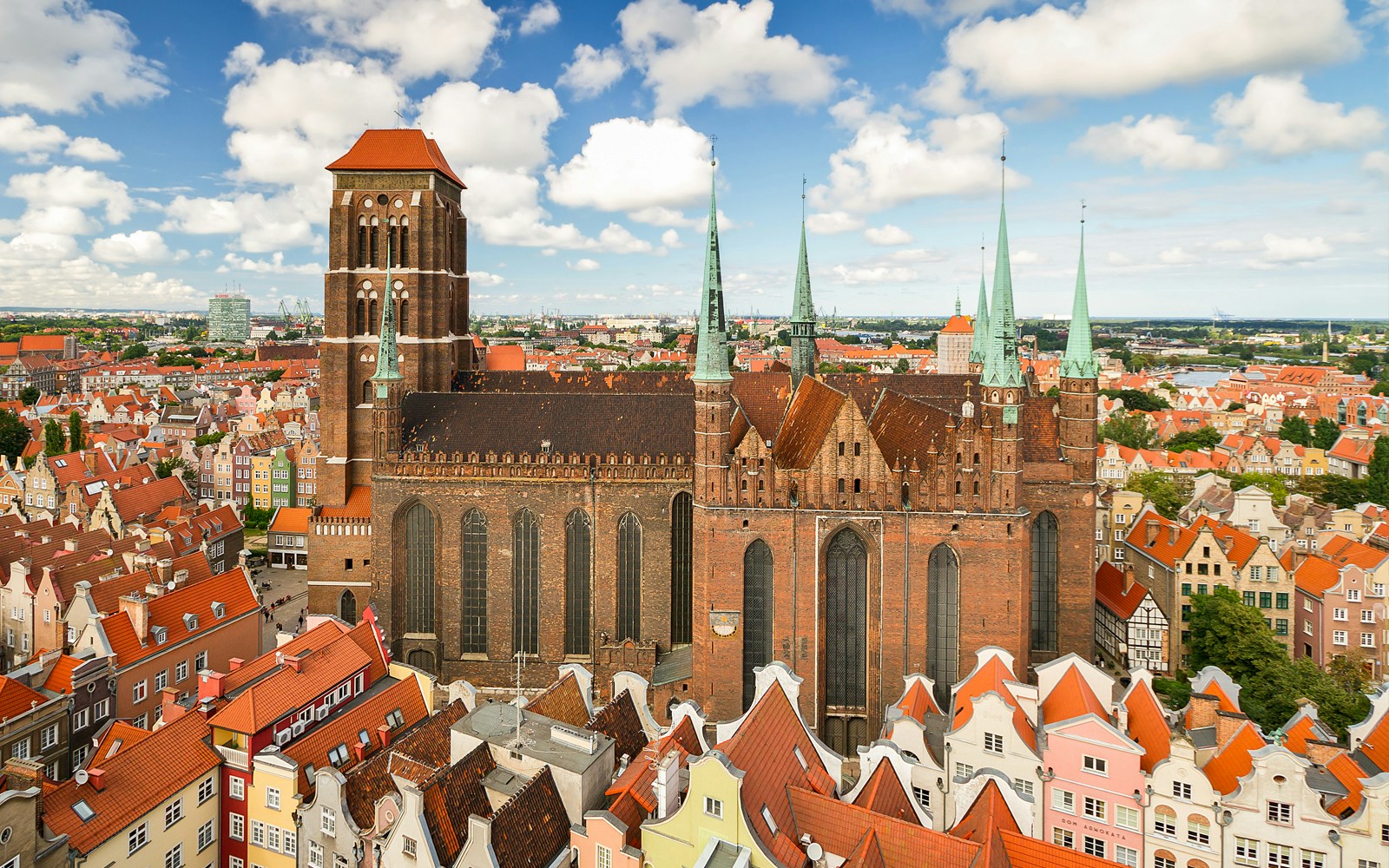 St. Mary's Cathedral in Gdansk old town surrounded by colorful historic buildings.