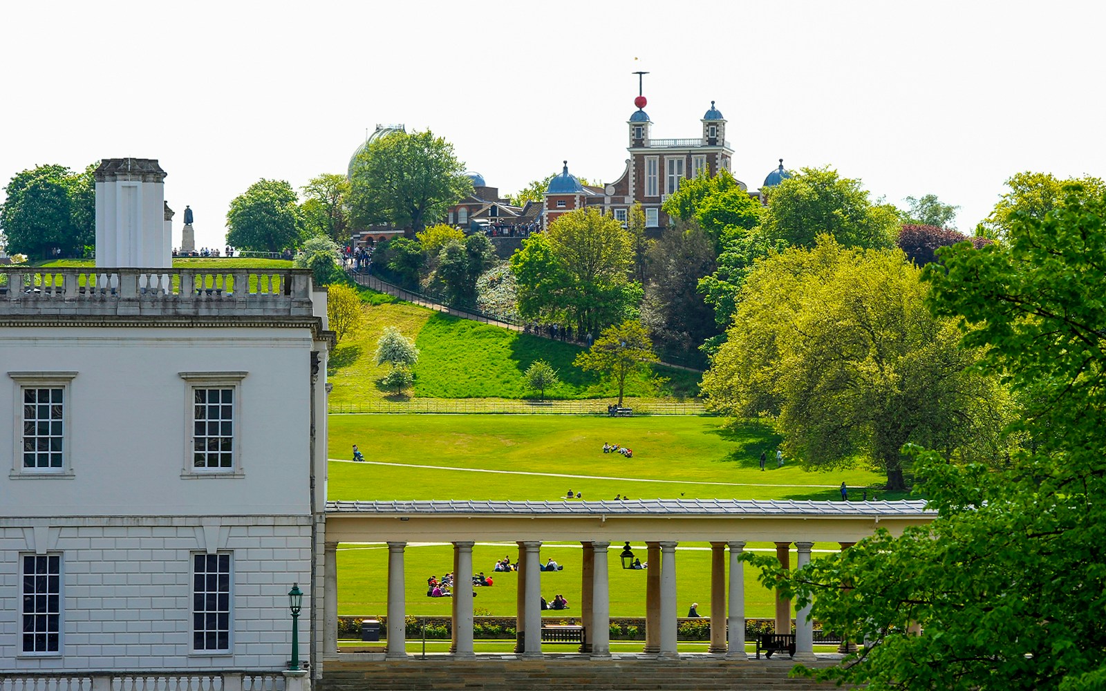 Visitors at Royal Observatory Greenwich, London, exploring the historic site and surrounding park.