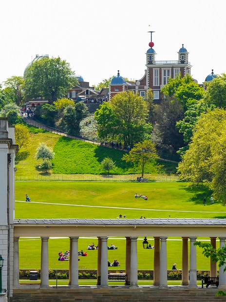 Visitors at Royal Observatory Greenwich, London, exploring the historic site and surrounding park.