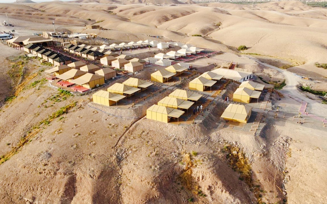 Aerial view of Agafay desert camp near Marrakesh with tents and surrounding arid landscape.