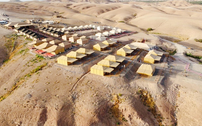 Aerial view of Agafay desert camp near Marrakesh with tents and surrounding arid landscape.