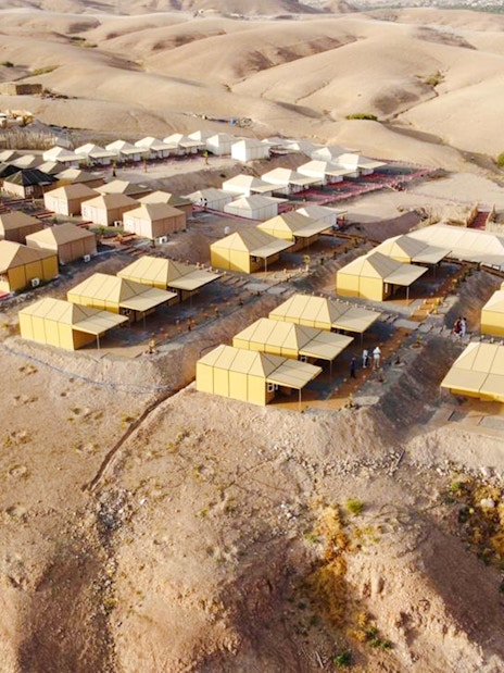 Aerial view of Agafay desert camp near Marrakesh with tents and surrounding arid landscape.