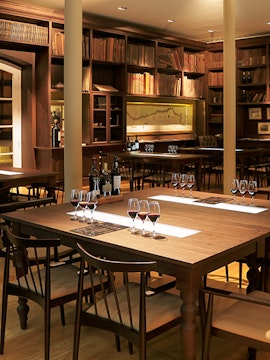 Graham Wine Tasting Experience setup with glasses and bottles in a cozy room.