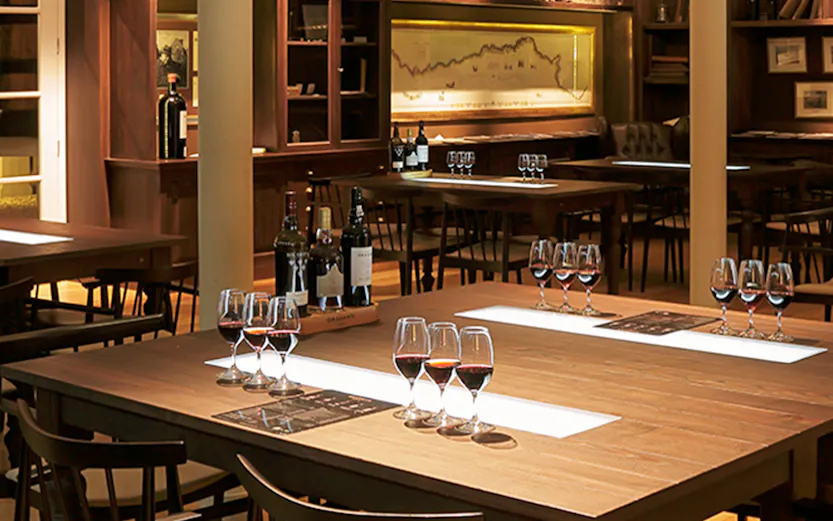 Graham Wine Tasting Experience setup with glasses and bottles in a cozy room.