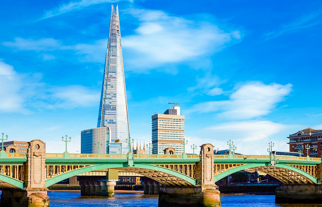 The Shard and Southwark Bridge over the River Thames in London, England.