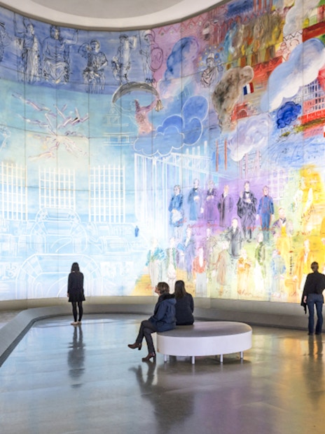 Visitors viewing colorful mural at Museum of Modern Art, Paris, France.