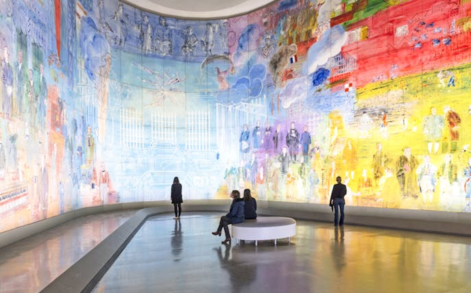 Visitors viewing colorful mural at Museum of Modern Art, Paris, France.