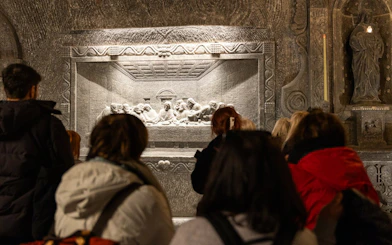 Visitors viewing a salt carving of the Last Supper in Wieliczka Salt Mine, Poland.