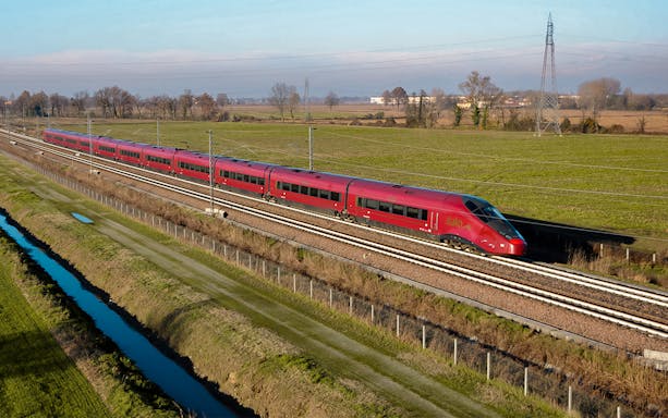 Italo train traveling through countryside between Milan and Florence.