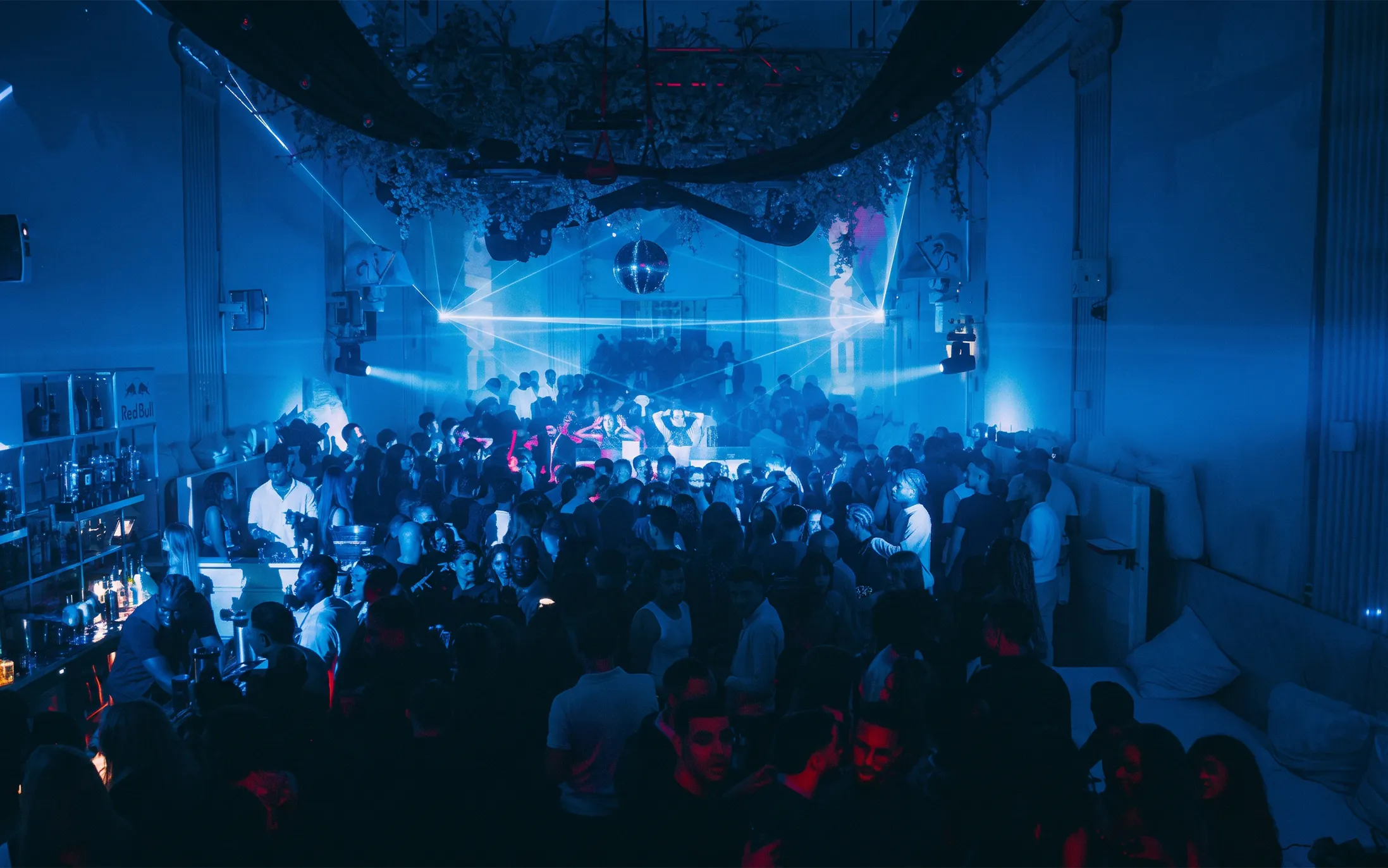 Crowded dance floor with blue lighting at Supperclub nightclub in Amsterdam.