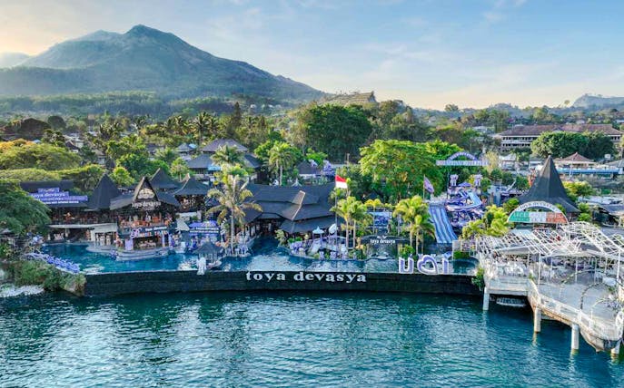 Aerial view of Toya Devasya Hot Spring Waterpark with Mount Batur in the background, Bali.