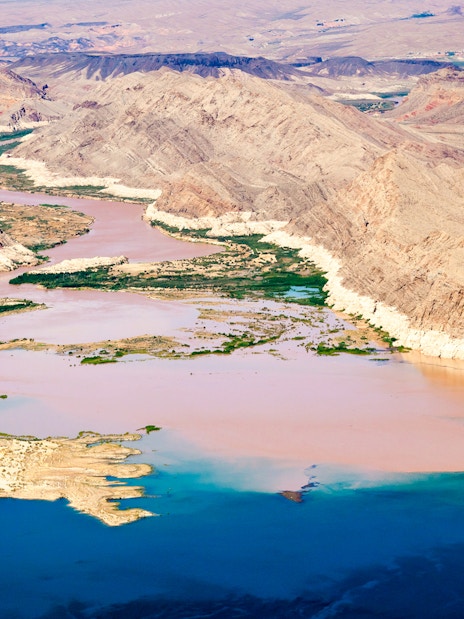 Colorado River flowing into Lake Mead surrounded by desert landscape.