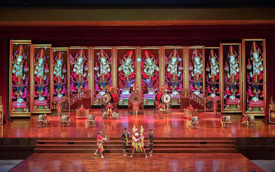 Traditional Thai performance at Nong Nooch Tropical Garden stage with vibrant backdrop.