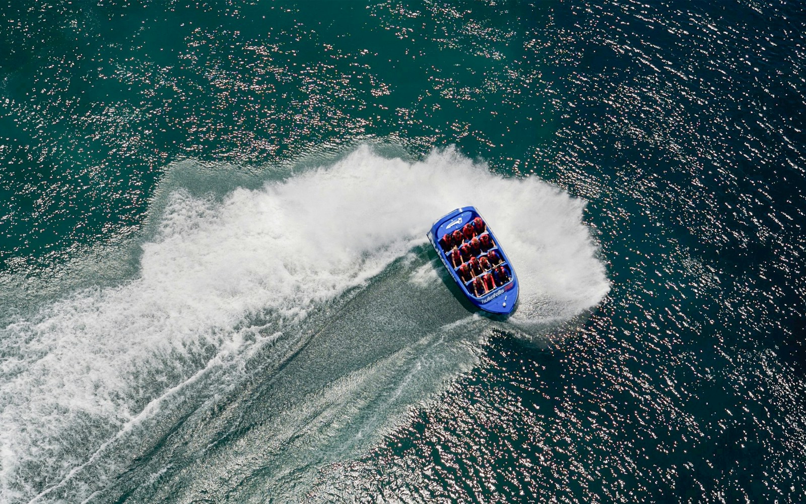 Aerial view of a jet boat making a turn on Huka Falls, New Zealand.