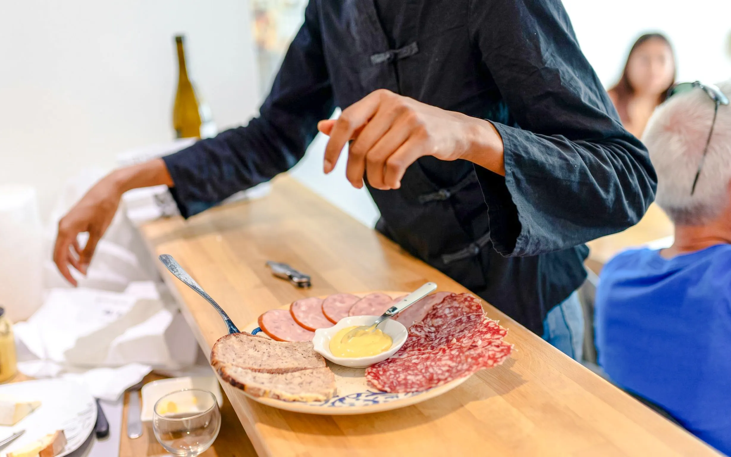 Charcuterie platter with pâté, salami, and mustard on Montmartre food tour.