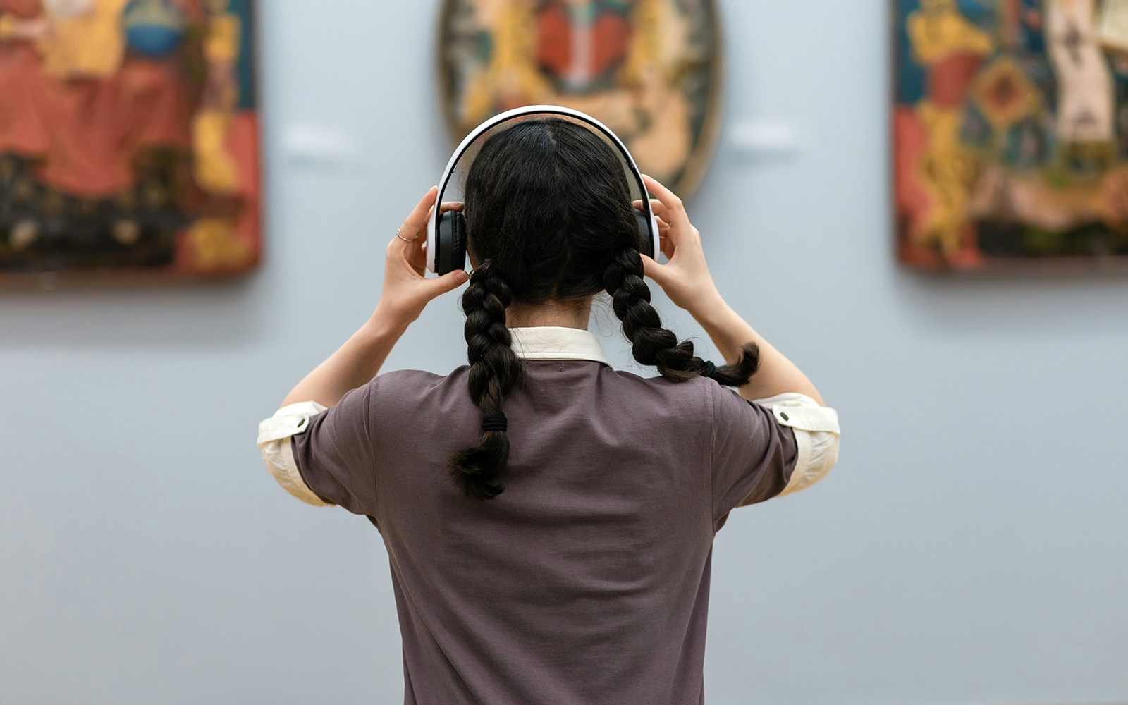 Visitor using audio guide at National Sintra Palace art exhibit.