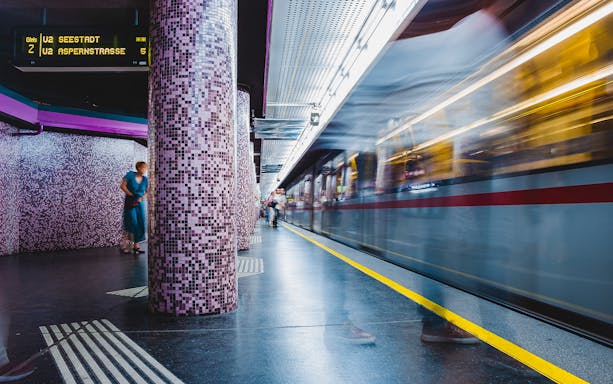 Vienna subway station with train arriving, part of QueerCityPass tour.