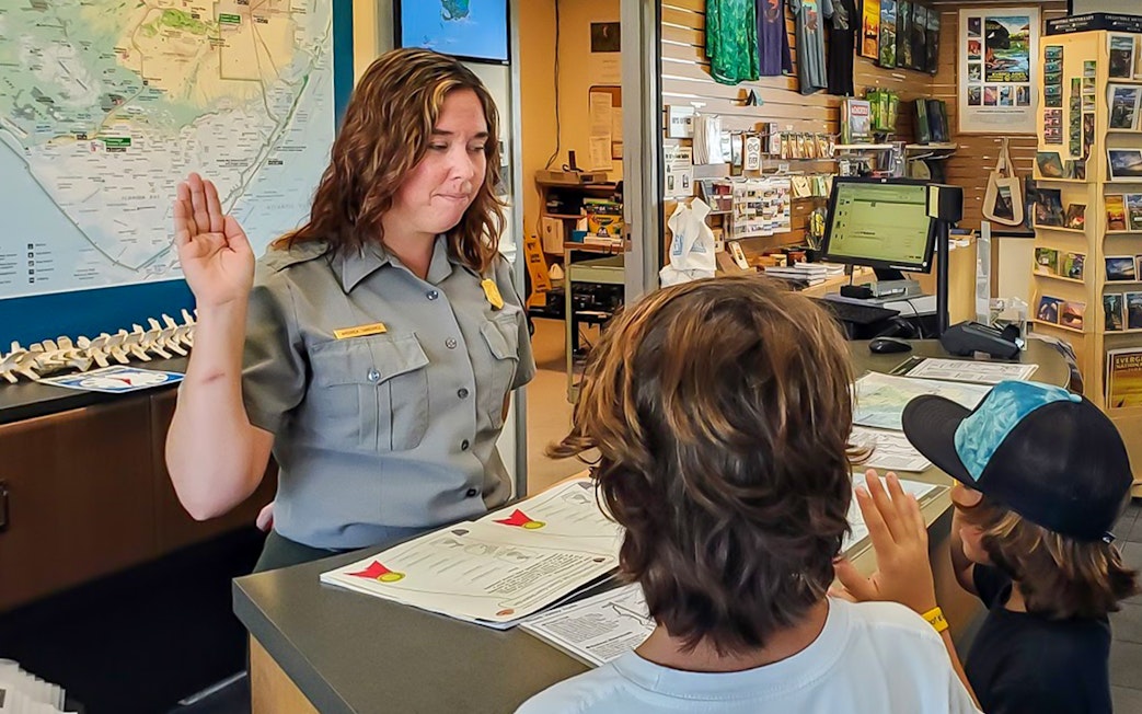 Guests interacting with park ranger at Everglades visitor center before guided nature walk.