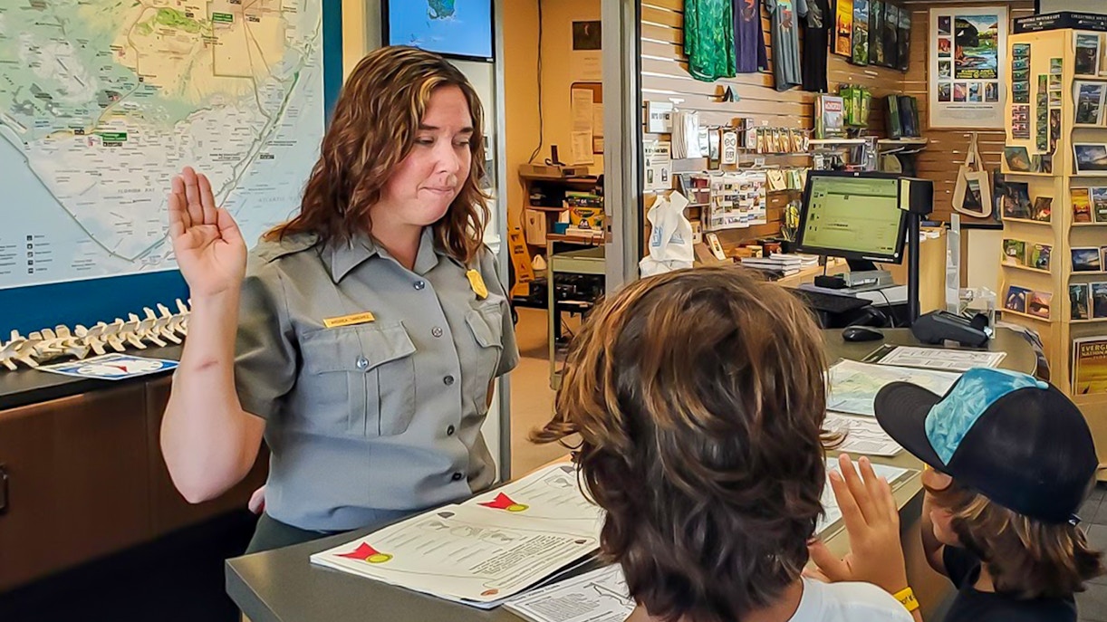 Guests listening to tour guide on Everglades Nature trail during guided walk.