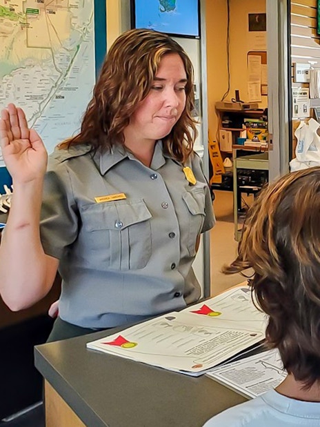 Guests interacting with park ranger at Everglades visitor center before guided nature walk.