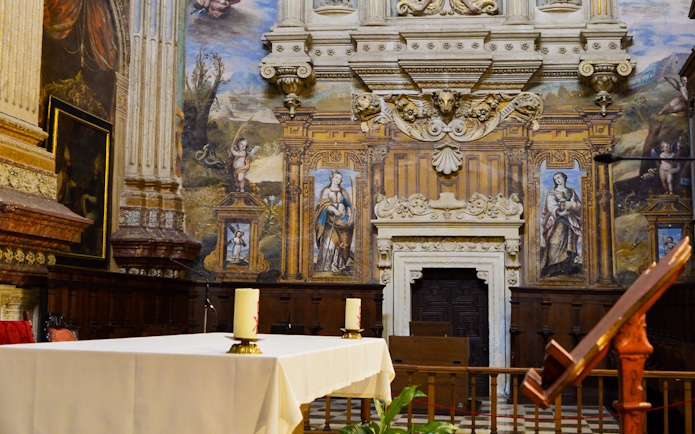 Royal Chapel of Granada interior with ornate altar and detailed frescoes.