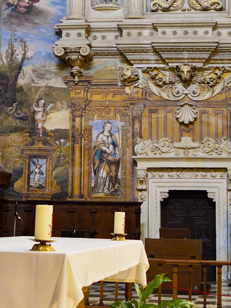 Royal Chapel of Granada interior with ornate altar and detailed frescoes.