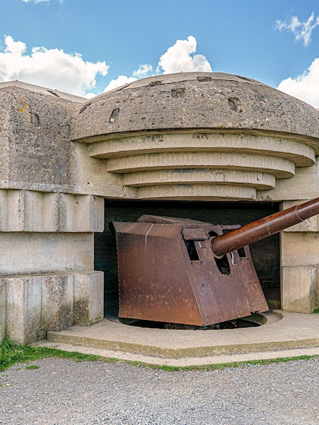 World War II bunker with artillery gun at Normandy D-Day landing site.