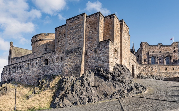 Edinburgh Castle stone walls and towers on Castle Rock, Scotland.
