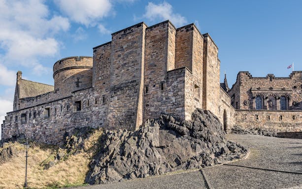 Edinburgh Castle stone walls and towers on Castle Rock, Scotland.