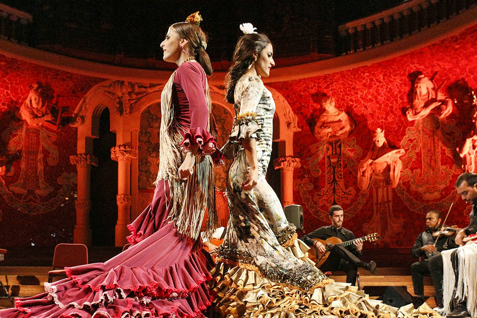 Flamenco dancers performing at Teatro EDP Gran Vía with musicians in the background.