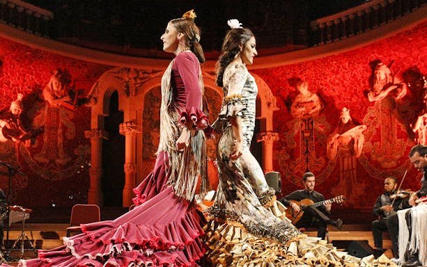 Flamenco dancers performing at Teatro EDP Gran Vía with musicians in the background.