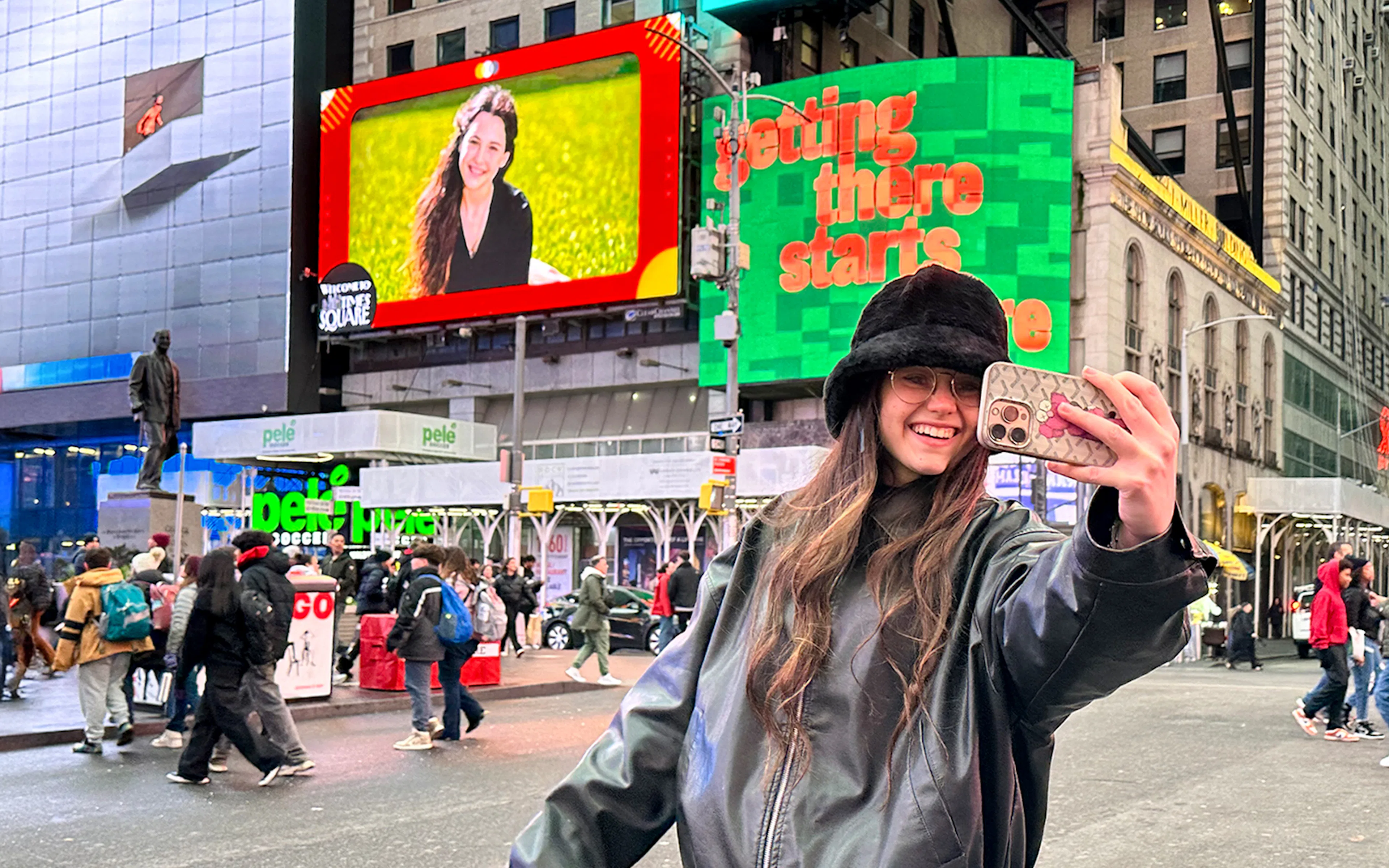 A person looking at a billboard with their picture on it
