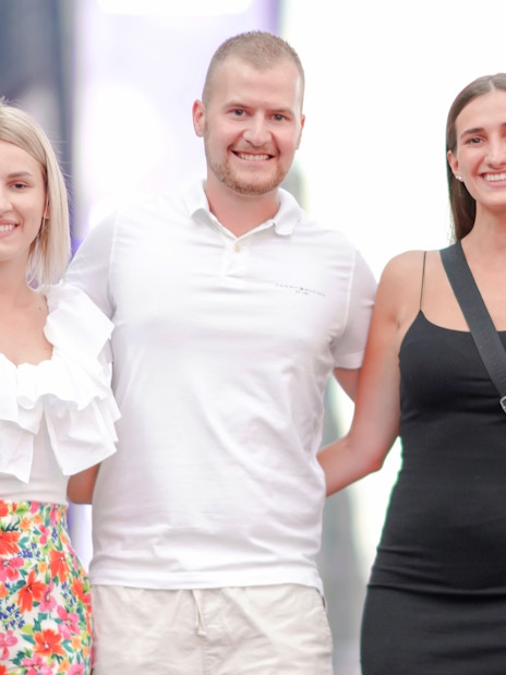 Group posing for a photoshoot in Times Square, NYC.