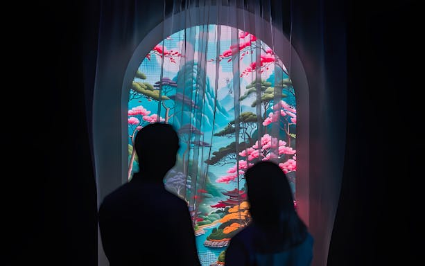 Silhouettes viewing digital art of a colorful landscape at ArtScience Museum exhibit.