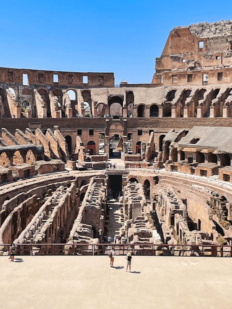 Tourists exploring the Colosseum arena in Rome, Italy.