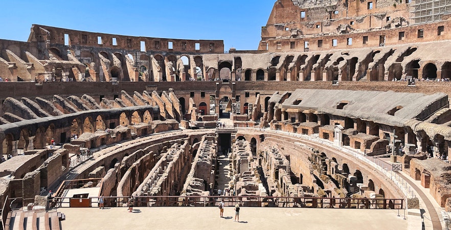 Tourists exploring the Colosseum arena in Rome, Italy.