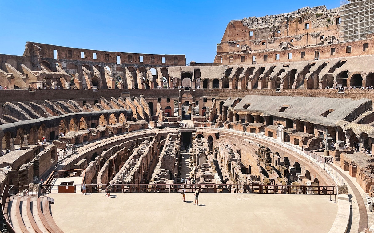 Tourists exploring the Colosseum arena in Rome, Italy.