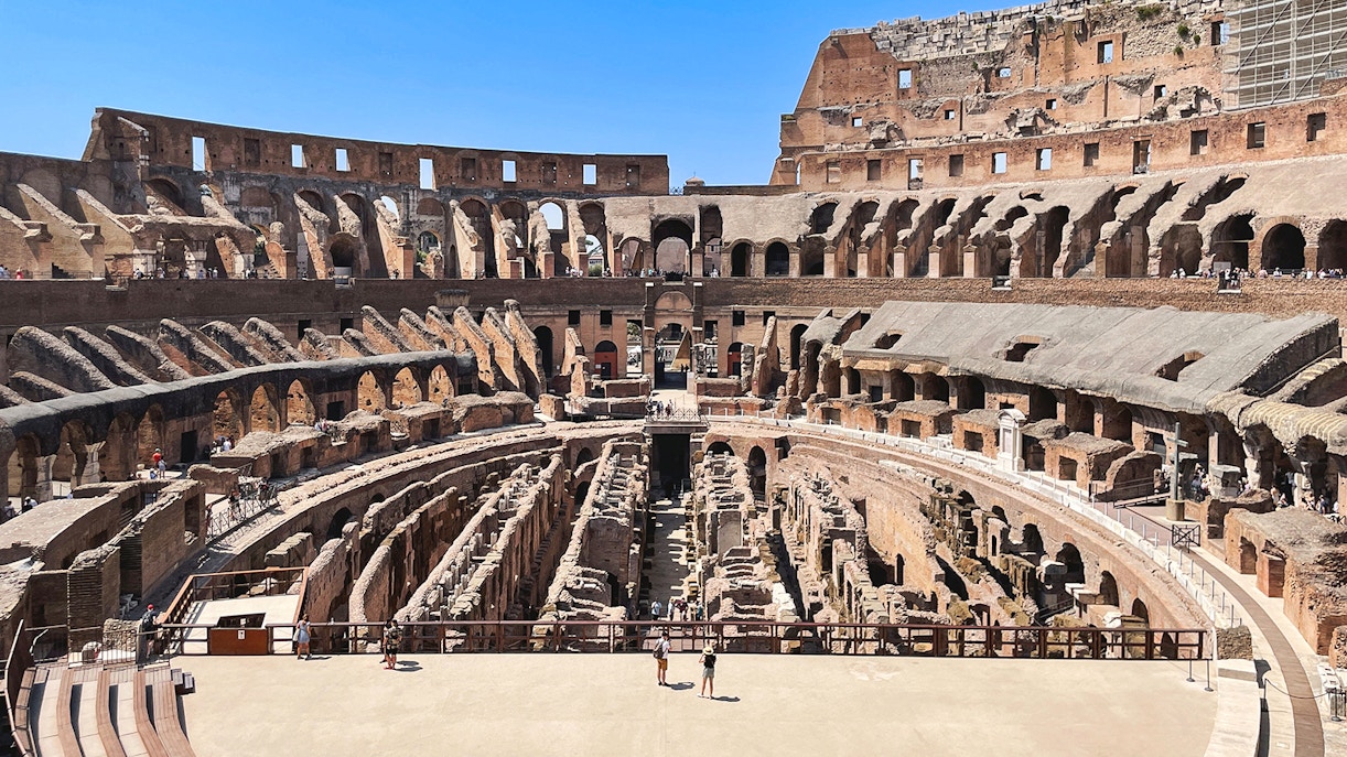 Tourists exploring the Colosseum arena in Rome, Italy.