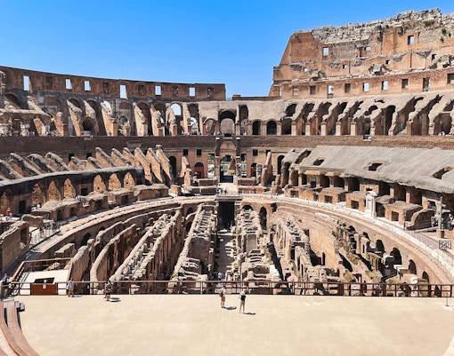 Tourists exploring the Colosseum arena in Rome, Italy.