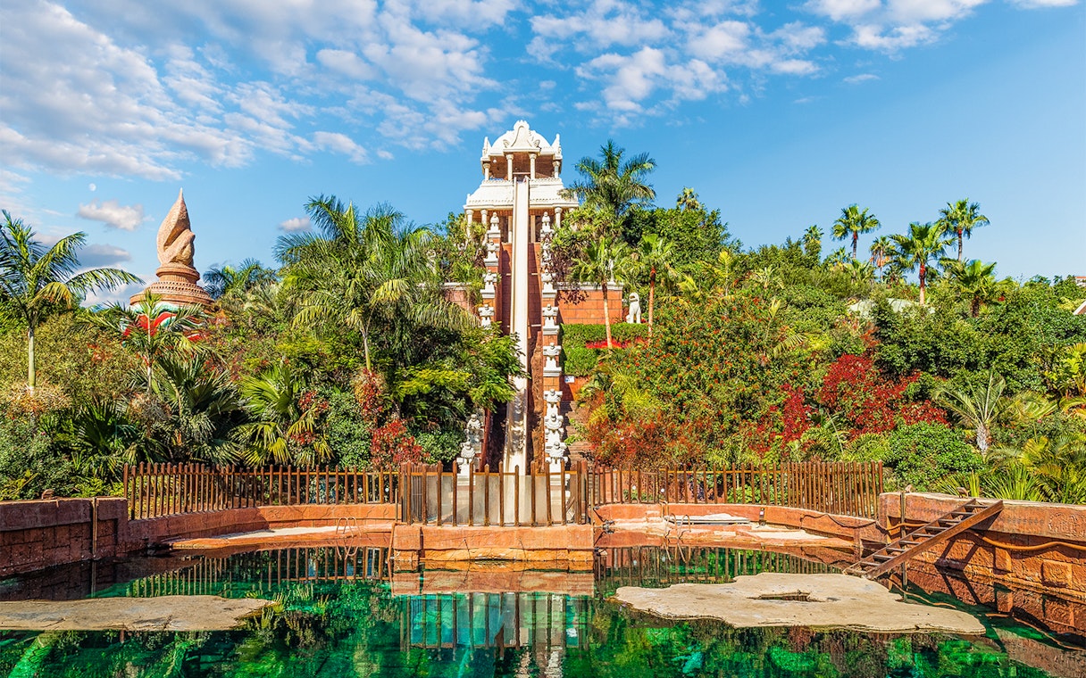 Tower of Power water slide at Siam Park, surrounded by lush greenery, Tenerife, Spain.