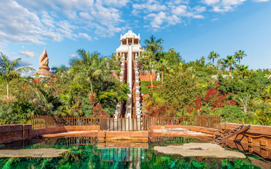Tower of Power water slide at Siam Park, surrounded by lush greenery, Tenerife, Spain.