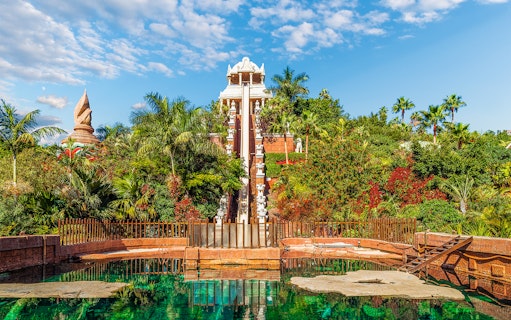 Tower of Power water slide at Siam Park, surrounded by lush greenery, Tenerife, Spain.